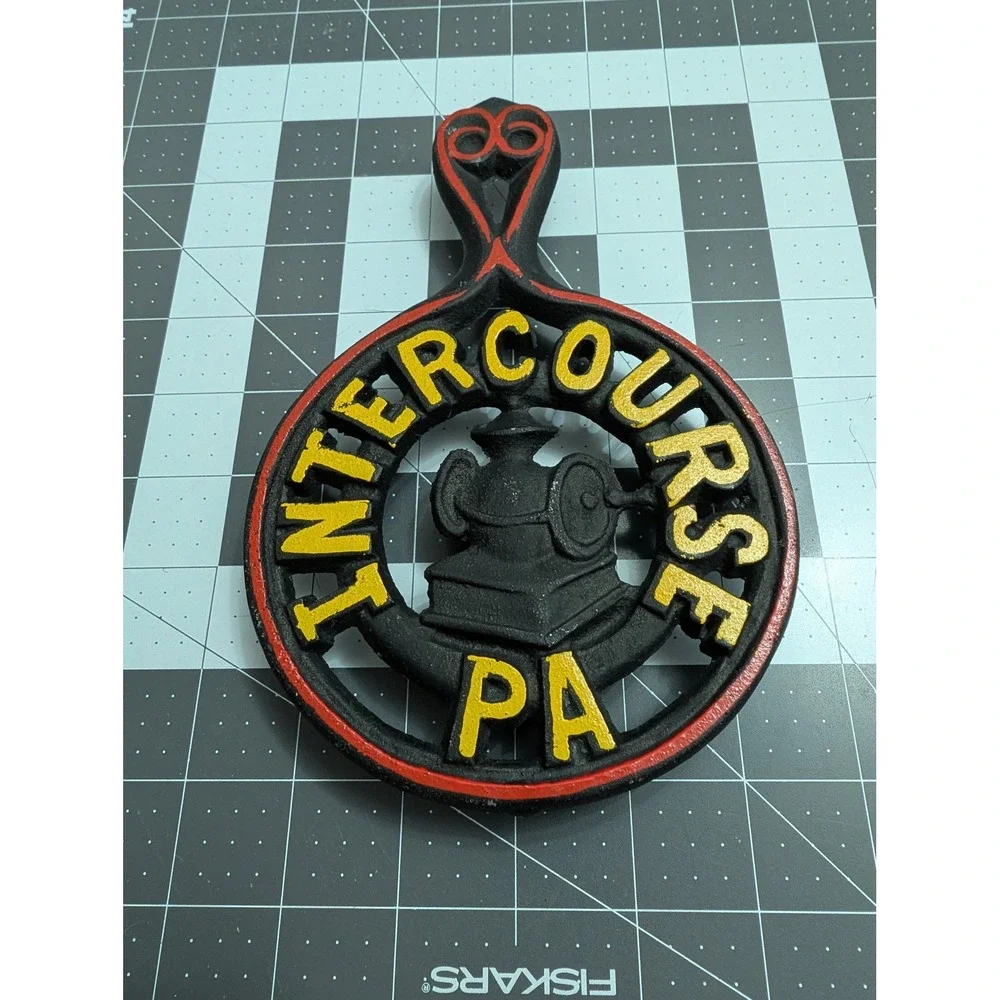 Intercourse PA cast iron footed trivet spoon rest red & yellow painting grain